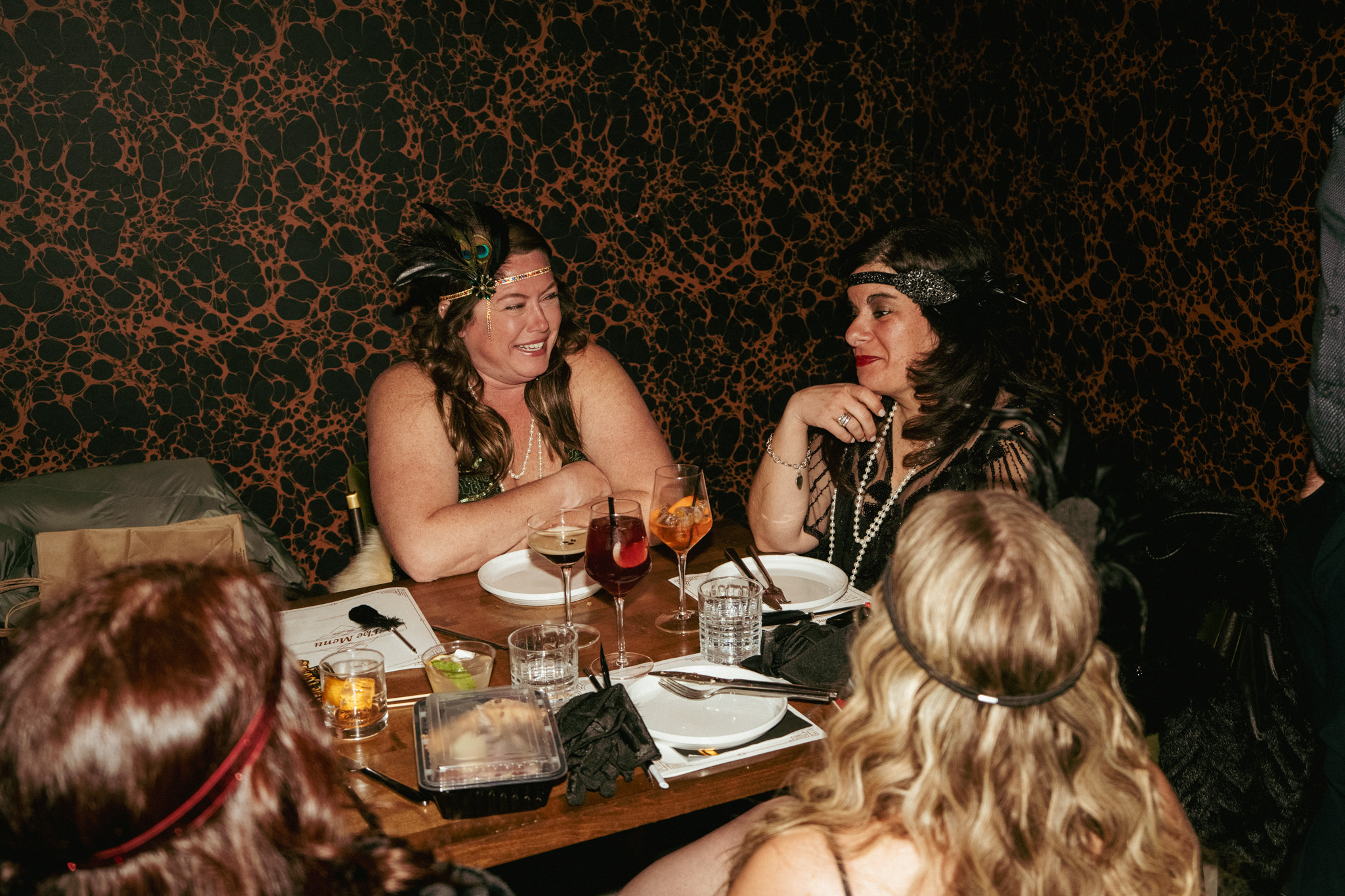 Guests dressed up at a Wooden Paddle Menu Party table