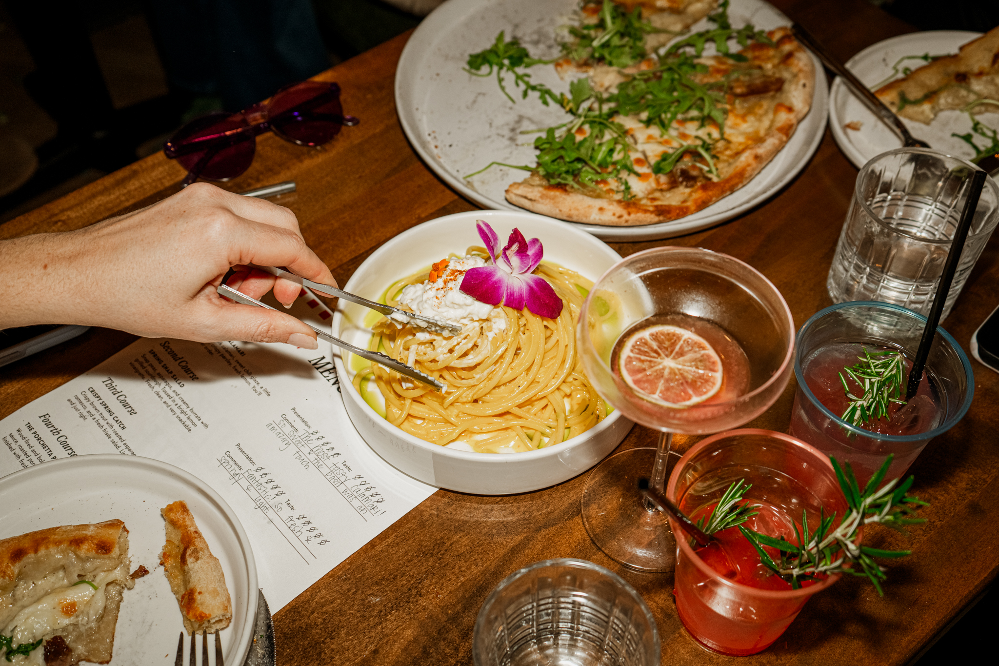 Pasta and pizza on the table with cocktails